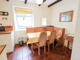 A kitchen with a dining table and chairs at Millcroft in Glenridding