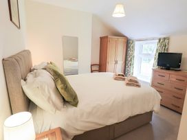 A bedroom with a bed and television at Millcroft in Glenridding