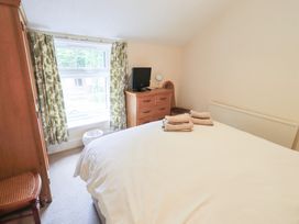 A bedroom with a bed and a television at Millcroft in Glenridding
