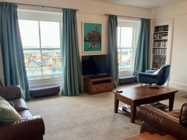 A living room with a television and coffee table at Westcliff in Newlyn