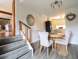 A dining room with a table and chairs at Cefn Uchaf Cottage Llanbedr