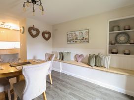 A dining room with a wooden table and chairs at Cefn Uchaf Cottage Llanbedr