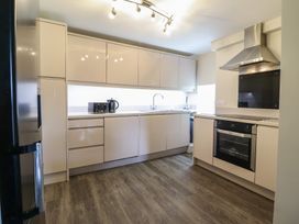 A kitchen with modern cabinets and appliances at Cefn Uchaf Cottage in Llanbedr