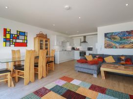 A living room with a dining area and kitchen at The View in Newquay