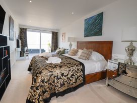 A bedroom with a large bed and a nightstand at The View in Newquay