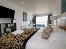 A bedroom with a bed and TV at The View in Newquay