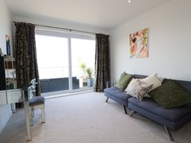 A living room with a sofa and sliding glass door at The View in Newquay