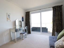 A living room with a mirror and a table at The View in Newquay