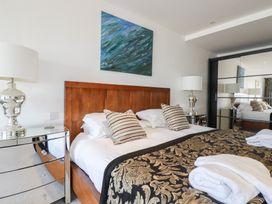 A bedroom with a bed and bedside lamps at The View in Newquay