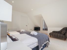 A bedroom with two beds and a television at The View in Newquay