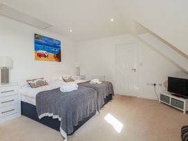 A bedroom with two beds and a television at The View in Newquay