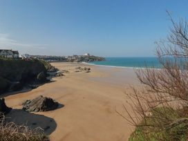 A beach with rocks and water at The View in Newquay