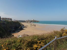 A beach with cliffs and houses near the shore at The View in Newquay
