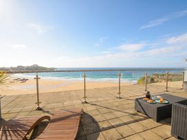 An outdoor balcony with ocean view and furniture at The View in Newquay