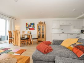 A living room with a dining area and kitchen units at The View in Newquay