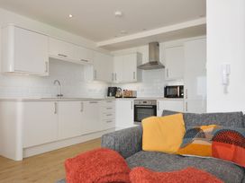 A kitchen with modern cabinets and appliances at The View in Newquay
