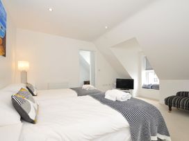 A bedroom with two beds and a television at The View in Newquay