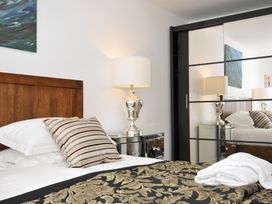 A bedroom with a bed and bedside lamp at The View in Newquay