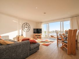 A living room with a sofa and dining area at The View in Newquay