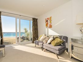 A living room with a sofa and sea view at The View in Newquay