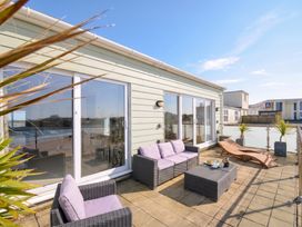 An outdoor area with seating and a coffee table at The View in Newquay