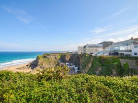 A coastal view with cliffs and buildings at The View in Newquay