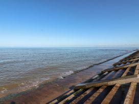 A view of the sea with a concrete stepped seawall on the right at Fairways in Prestatyn