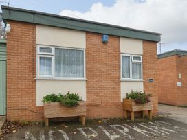 A brick building with two windows and flower boxes below them at Fairways Prestatyn