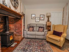 A living room with a sofa and armchair at Riverlea in Dyserth