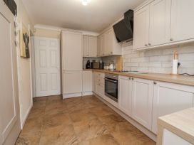 A kitchen with cabinets and appliances at Riverlea in Dyserth