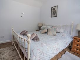 A bedroom with a bed and bedside tables at Riverlea in Dyserth