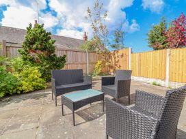 A garden with seating and plants at Riverlea in Dyserth