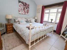 A bedroom with a bed and window at Ty Cerrig in Dyserth