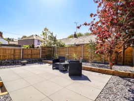 A garden with patio area and chairs at Ty Cerrig Dyserth