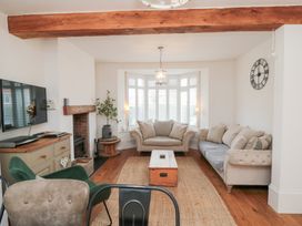 A living room with a television and sofa at Harriet's Cottage in Briggswath