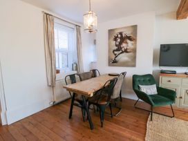A dining room with a table and chairs at Harriet's Cottage in Briggswath