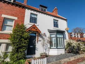 A house with a door and windows at Harriet's Cottage in Briggswath