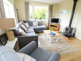 A living room with a sofa and coffee table at Sea View in Benllech
