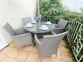 An outdoor seating area with a table and chairs at Sea View in Benllech