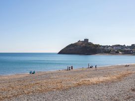 A beach with pebbles and people near water at a coastal location in Dubrovnik