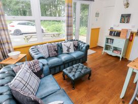 A living room with a blue sofa and coffee table at Driftwood in Roch