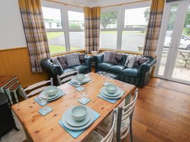A dining room with a table set for meals at Driftwood in Roch