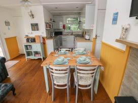 A dining room with a table and chairs at Driftwood in Roch
