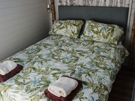 A bedroom with a bed and pillows at Reflection in Longtown