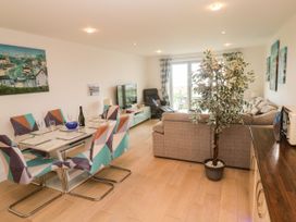 A living room with a dining area and sofa at Ocean Seven in Newquay