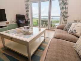 A living room with a coffee table and sofa at Ocean Seven in Newquay