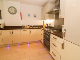 A kitchen with appliances and cabinets at Ocean Seven in Newquay