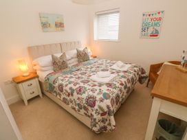 A bedroom with a bed and nightstand at Ocean Seven in Newquay