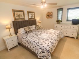 A bedroom with a bed and dressers at Ocean Seven in Newquay
