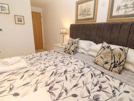 A bedroom with a bed and decorative pillows at Ocean Seven in Newquay